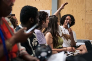 man raising his hand at an event man raising his hand at an event